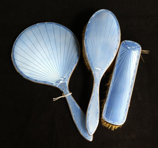 A 1930s silver and blue enamel three piece brush and mirror set.